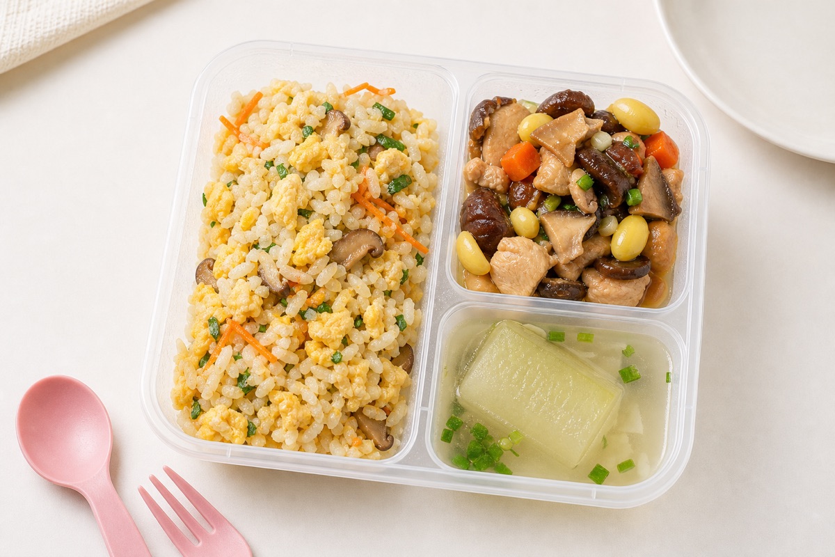Egg fried rice with chicken mushroom side and winter melon soup in a My Little Boss meal tray